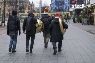 Four musicians with wind instruments and Santa Claus hats, Helsinki, Finland