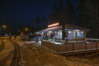 Illuminated rest stop, Stop'n Go Grilli or grill on the Finnish motorway in a wintry atmosphere,