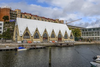 Large historic market hall in Gothenburg with pointed roof on the water, Gothenburg, Västra