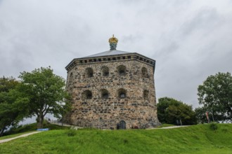 Massive historic stone fortress Skansen Kronan with a decorative crown on a hill surrounded by