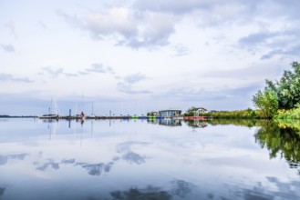 Tranquil Dümmer See with several boats in the harbor and clouds, Dümmerlohausen, Damme, Lower