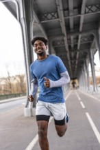 Smiling black man jogging on pariss bir hakeim bridge, staying fit and active in casual sportswear