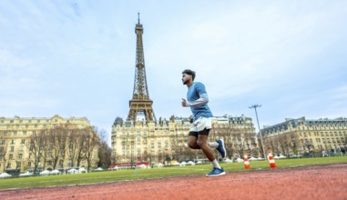 Male athlete intensely running on a red synthetic track, training and exercising with the iconic