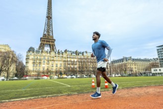 Male athlete running on a sports track in paris, focusing on fitness and active lifestyle in an