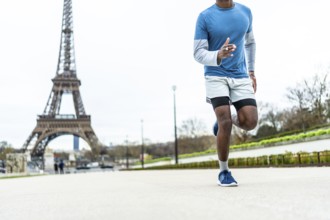 Athletic man jogging outdoors during his daily fitness workout routine, enjoying an active healthy