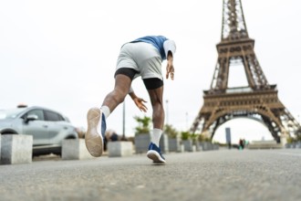 Athlete training outdoors in urban paris, enjoying fitness and an active lifestyle while jogging