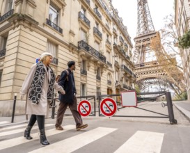 Diverse couple crossing a pedestrian street in paris, enjoying a city trip together with classical