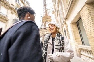 Happy couple happily conversing on a picturesque paris street with the iconic eiffel tower in the