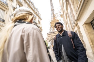 Happy young african american man smiling at his partner while enjoying a romantic trip in paris,
