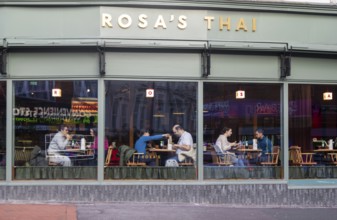 People eating at tables inside Rosa's Thai restaurant, Kings Road, Reading, Berkshire, England, UK