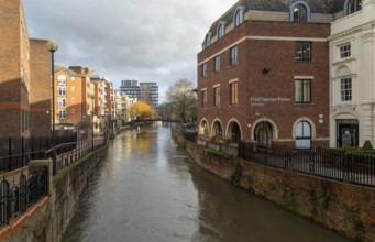 River Kennet flowing past apartment housing and businesses, view east from London Street, Reading,