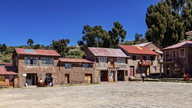 Traditional houses in a quiet village in the Andes, surrounded by nature and under a clear sky, The