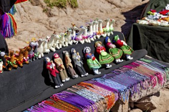 Handmade dolls and animals in traditional clothing at a souvenir market in Peru, souvenirs and
