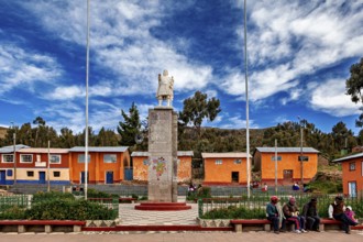 Central square with stone monument, colorful houses and people on benches, cloudy sky, Great Inca