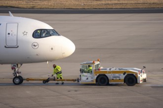Lufthansa City Airbus A320neo is pushed from the gate onto the taxiway, ready to go, to