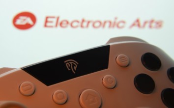 Dhaka, Bangladesh- 24 Mar 2025: A close-up of a gamepad with the Electronic Arts seen on screen in