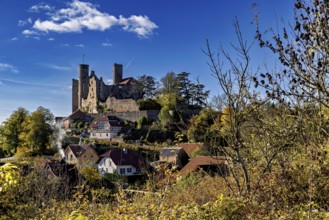Autumn view of the village with castle on a hill under a clear sky, Hanstein Castle near Bornhagen