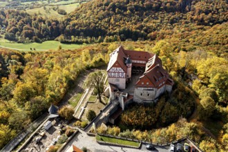 Historic castle perched over colorful autumn forest, landscape viewed from the air, Bodenstein