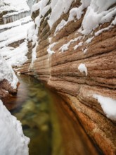 Taugl or Tauglbach flows through the snow-covered and icy red gorge, also Marmorklamm, Bad Vigaun,