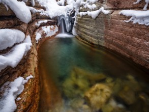 Taugl or Tauglbach flows through the snow-covered and icy red gorge, also Marmorklamm, Bad Vigaun,