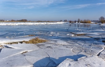 Ice on the banks of the Elbe and remnants of snow in the foothills of the Elbe on a clear winter