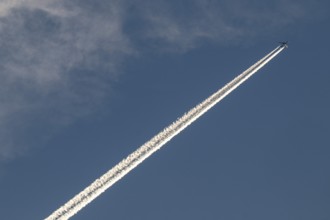 Contrails and passenger jets high in the sky