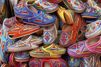 Sales stand with traditional colorful slippers at a market in Marrakech, historic old town, Medina,