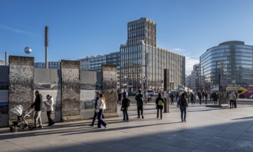 Wall segment, tourists and passers-by at Potsdamer Platz, Berlin, Germany