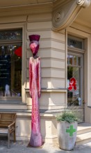 Wooden figure in front of a pharmacy, Luisenplatz, Potsdam, Brandenburg, Germany
