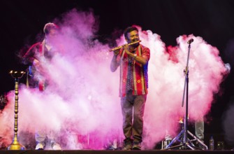 Flutist Dilip Hira performs during a cultural evening program at Shilpgram Mohotsav 2026 in