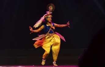 An artist perform classical Manipuri Ras Leela during a cultural evening program at Shilpgram