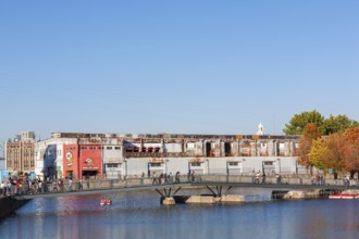 Pedestrian walkway bridge over Bonsecours basin leading to Parc du Bassin Bonsecours in autumn, Old