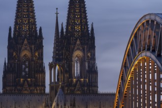 Evening atmosphere, Cologne Cathedral illuminated with LED lamps and the Hohenzollern Bridge,