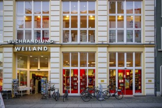 Weiland bookstore with bicycles parked in front of it, at the fish market in the Hanseatic City of
