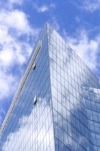 Skyscraper, high-rise office building with sky reflected in mirrored glass panes, Vilnius Central
