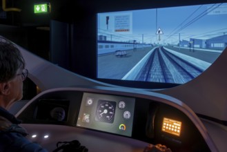 Visitor operating locomotive driving simulator at Train World, railway museum in Schaerbeek,