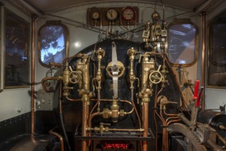 Pressure gauges and valves in steam engine cab, driver's compartment of steam locomotive at Train