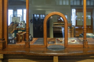 Vintage ticket counter in former ticket hall at the Schaerbeek railway station at Train World,