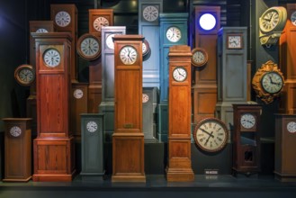 Collection of antique wooden railway station clocks at Train World, railway museum in Schaerbeek,