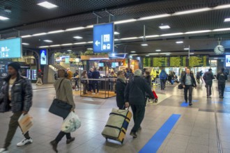 Travelers, commuters, tourists in the main hall of the NMBS Brussels-South railway station, Gare de