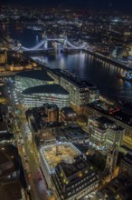 Aerial view from Sky Garden over Tower Bridge, the River Thames and illuminated highrise buildings