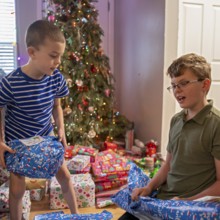 Denver, Colorado - Brothers open Christmas presents on Christmas morning