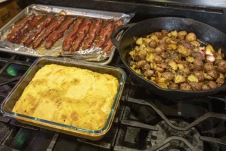 Denver, Colorado - Eggs, potatoes, and bacon on the stove for breakfast