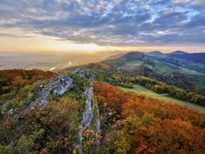 View from the Gisliflue of an autumn-colored forest, behind the Jurassic foothills with water fluh