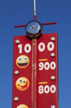 Close-up of High Striker game of strength with numbered score levels at Fun Show traveling