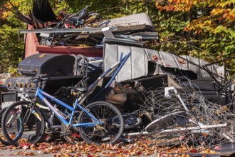 Pile of discarded metal objects including bicycles, sheet metal cladding, pipes, steel wire waiting