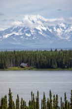 House on Lake Willow Lake, Taiga landscape with high glaciated mountain peak Mount Drum, Wrangell