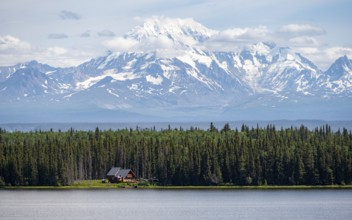 House on Lake Willow Lake, Taiga landscape with high glaciated mountain peak Mount Drum, Wrangell