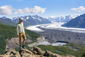 Young man enjoying the view, view of impressive mountain landscape with Matanuska glacier and
