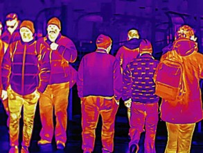 Thermal image or thermography, symbolic photo, interpolated. People traveling in urban areas.